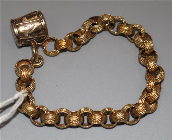 A late Victorian gold fancy link bracelet with drum charm.